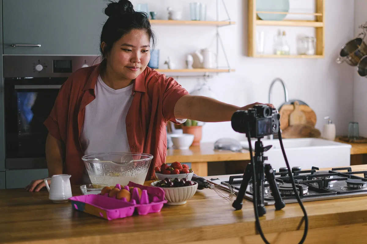 A creator filming content in her kitchen